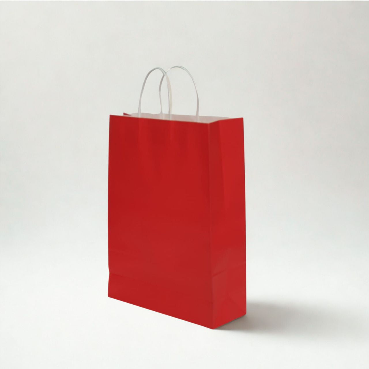 Medium red kraft paper bag with twisted paper handles for retail and gifting