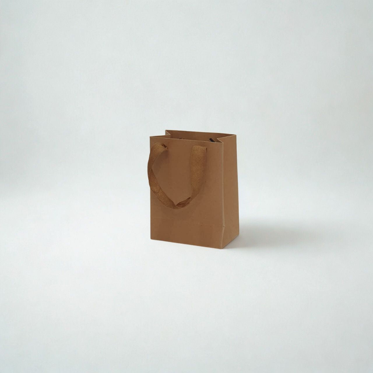 A5 size brown kraft paper gift bag with ribbon handles for small gifts